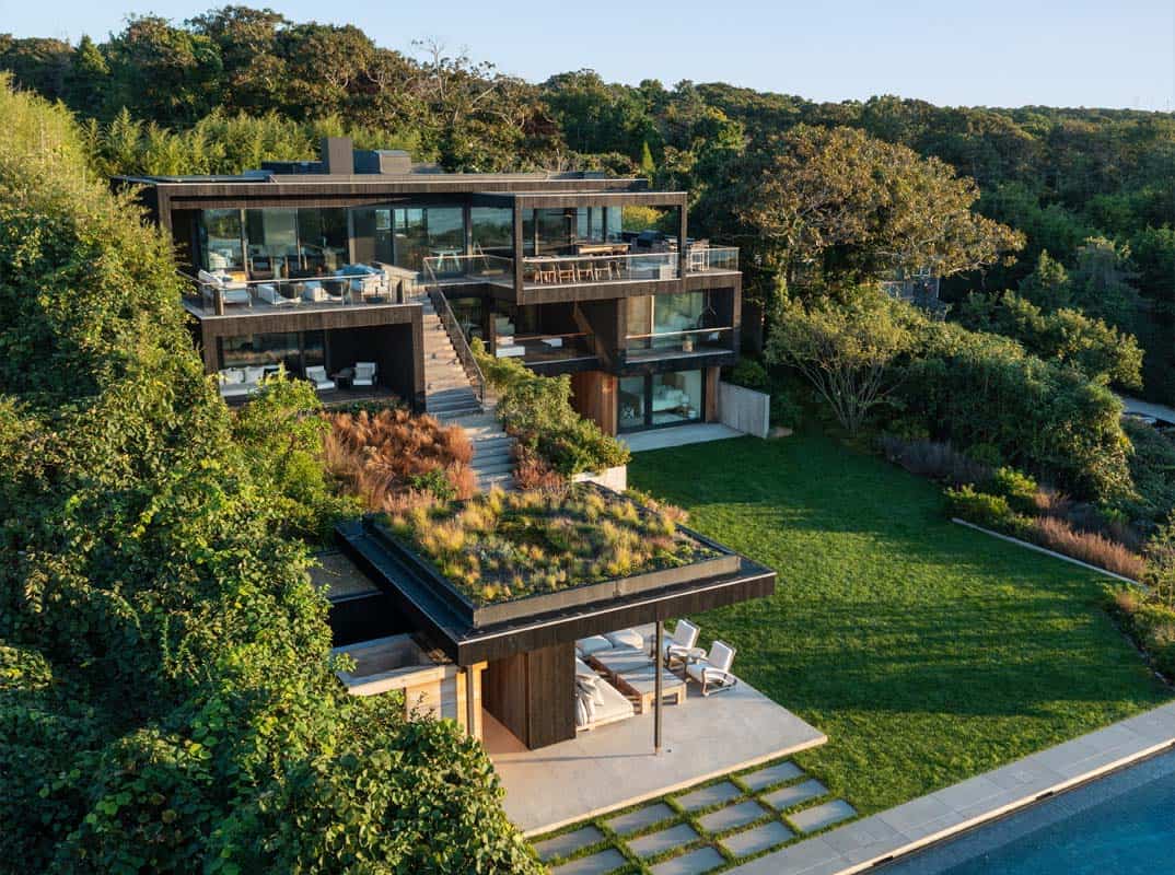 contemporary oceanside home exterior with a green roof