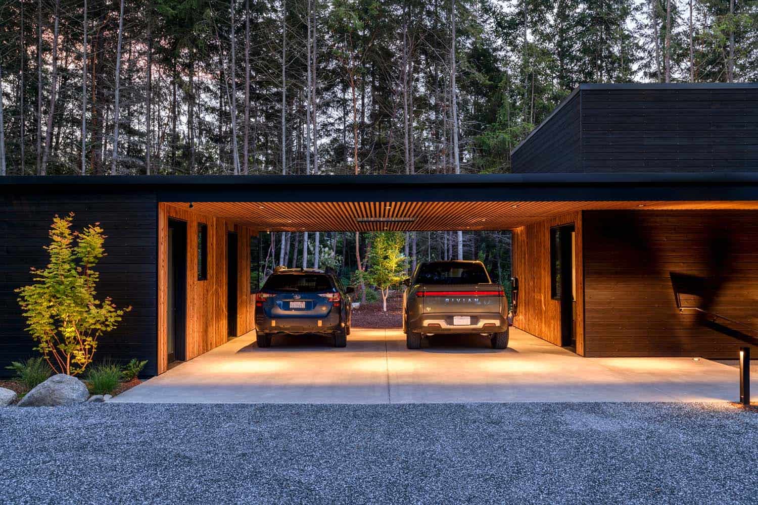 contemporary waterfront house garage exterior at dusk