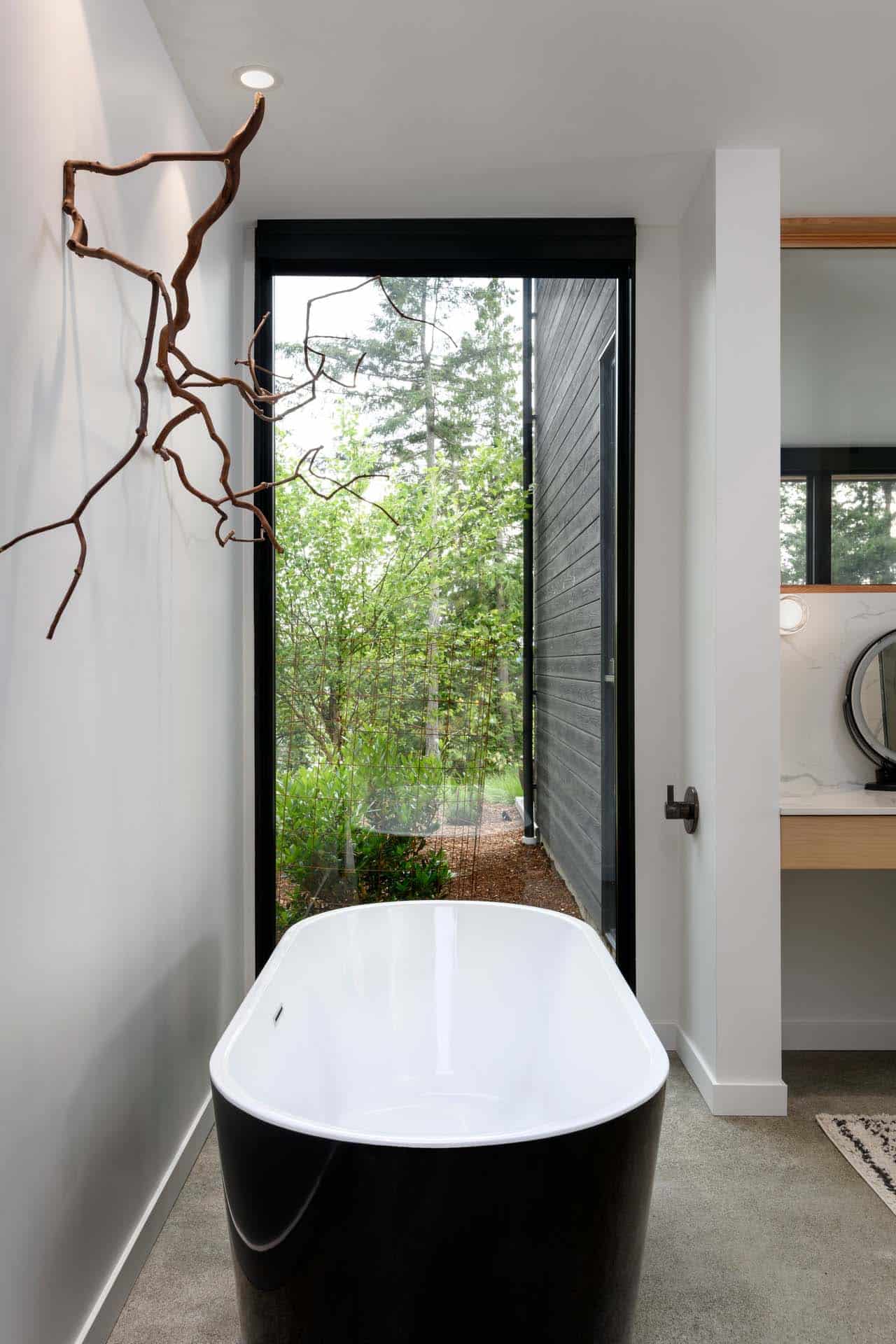 contemporary bathroom with a freestanding tub and large window