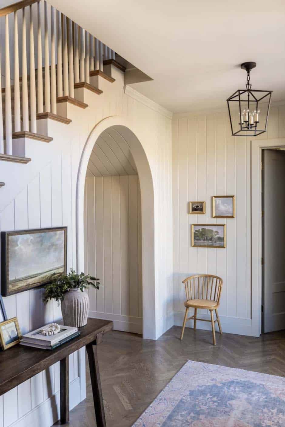 transitional hallway with an arched passageway leading into the main living spaces