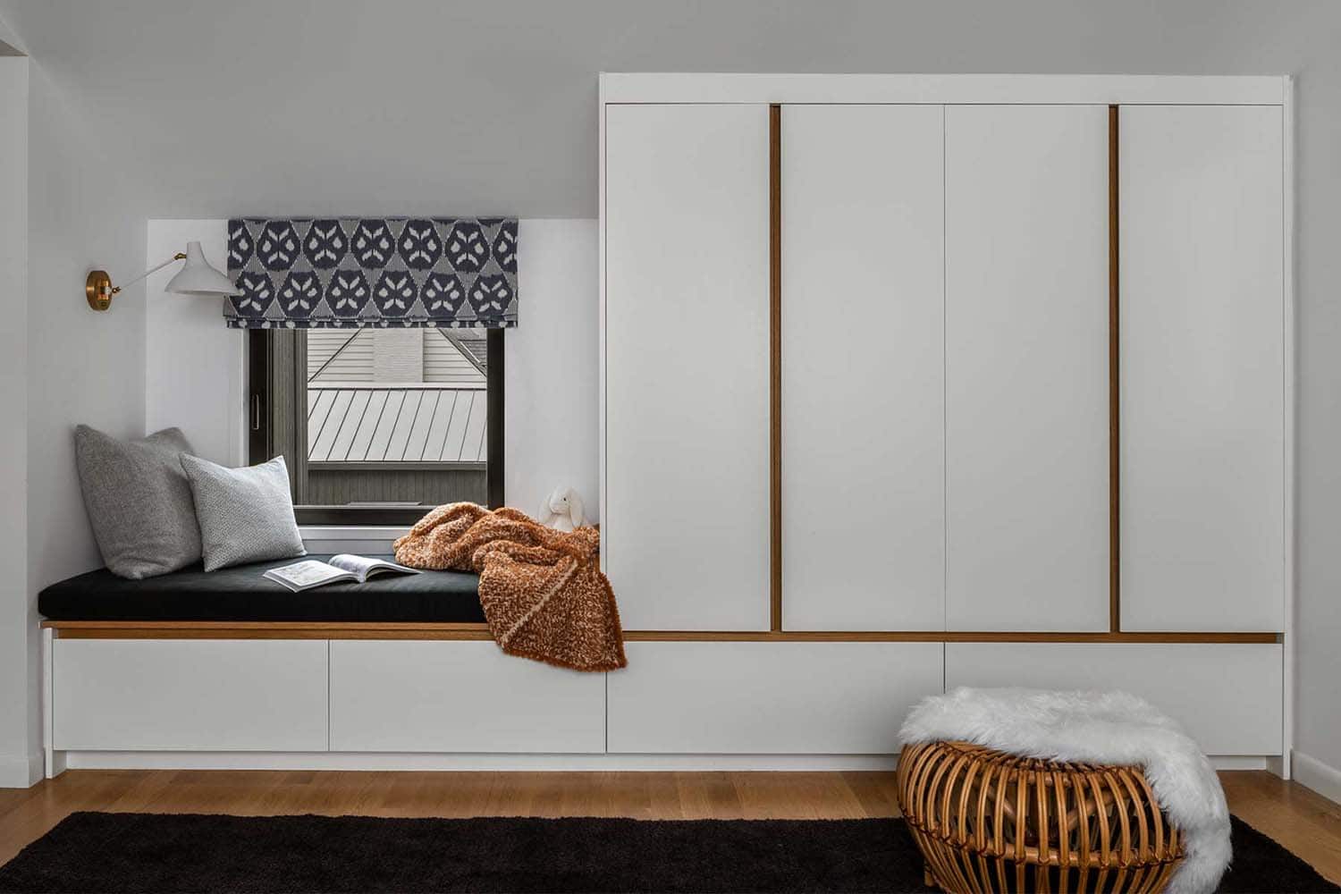 modern bedroom with a built-in wardrobe and integrated window seat