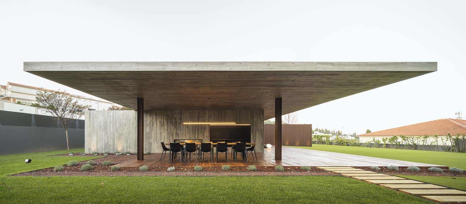 minimalist home exterior with a covered patio and outdoor dining furniture