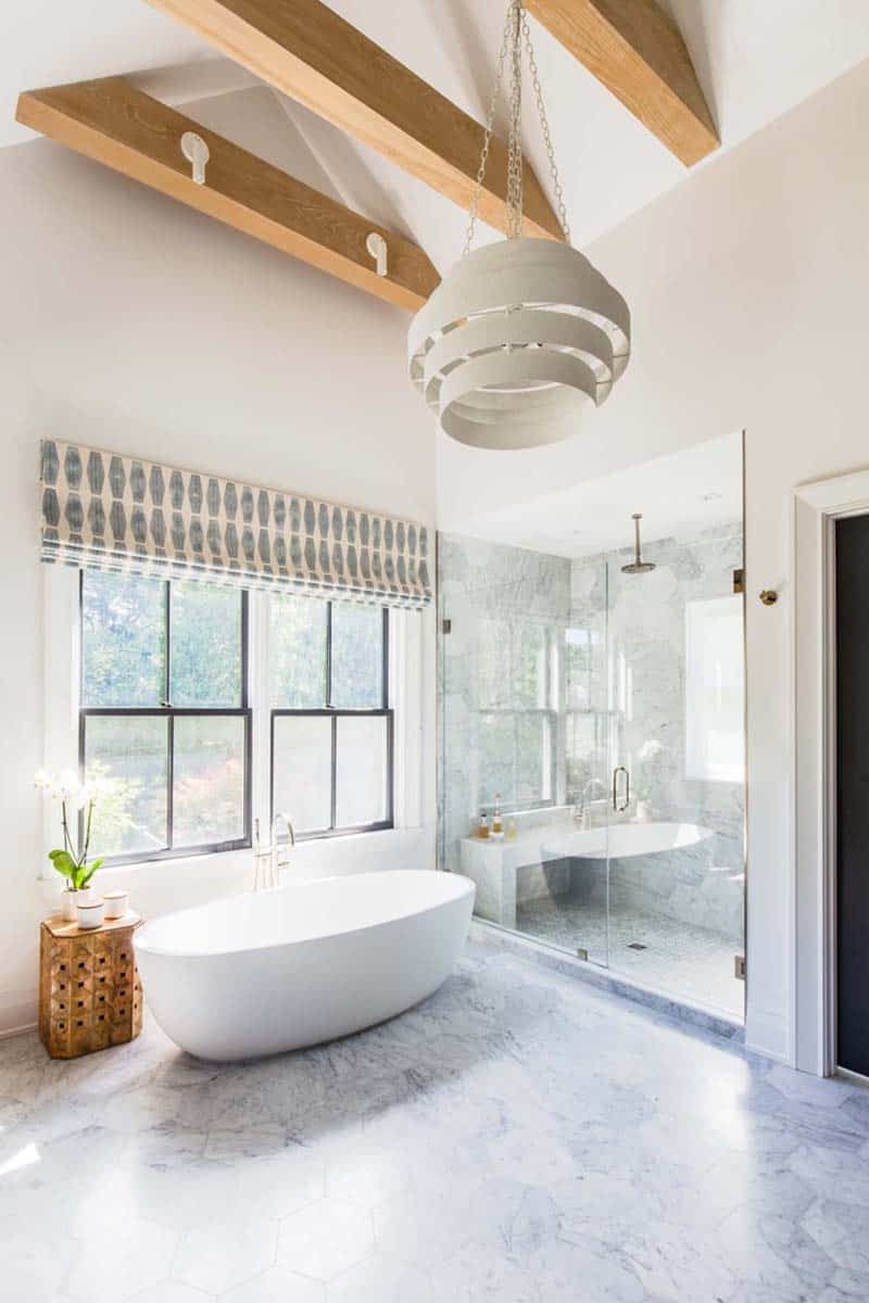 farmhouse modern bathroom with a freestanding tub and vaulted ceiling