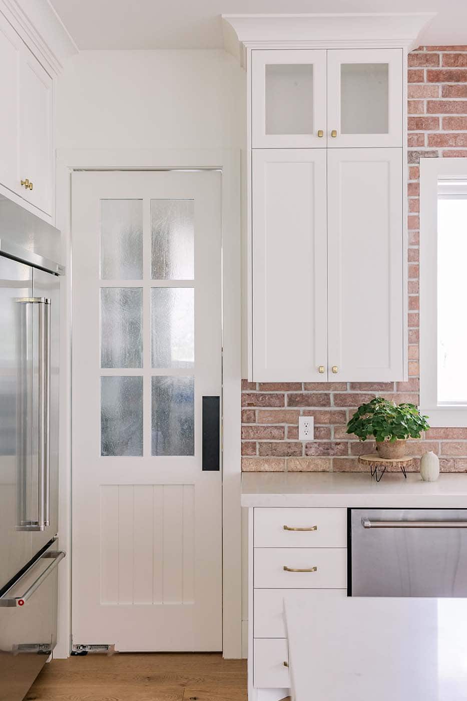 modern farmhouse kitchen with a door into the pantry