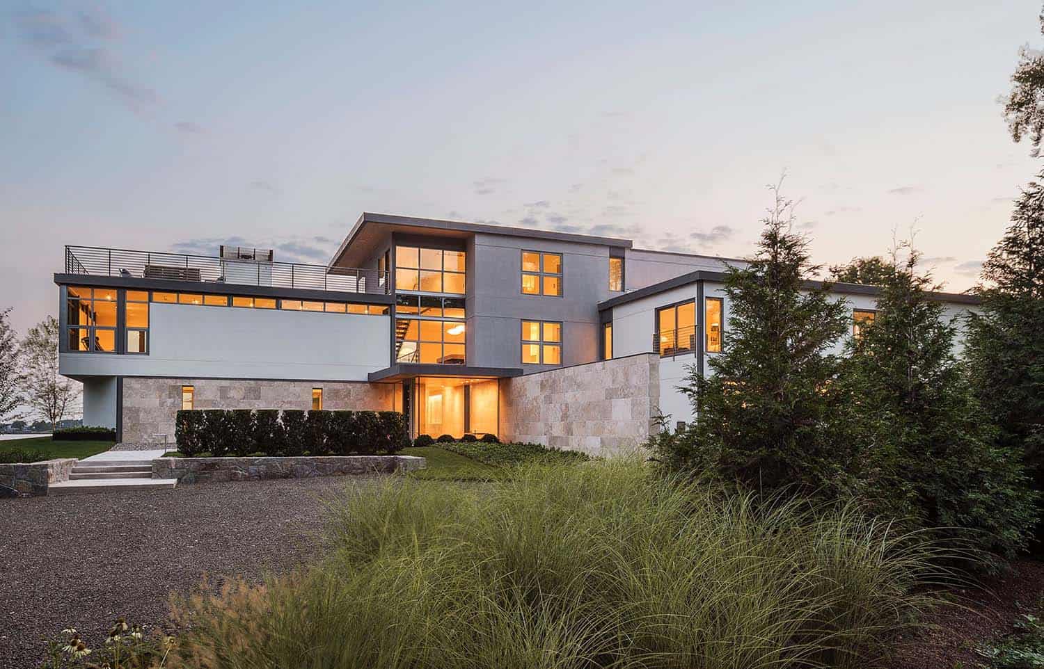 modern waterfront home exterior at dusk