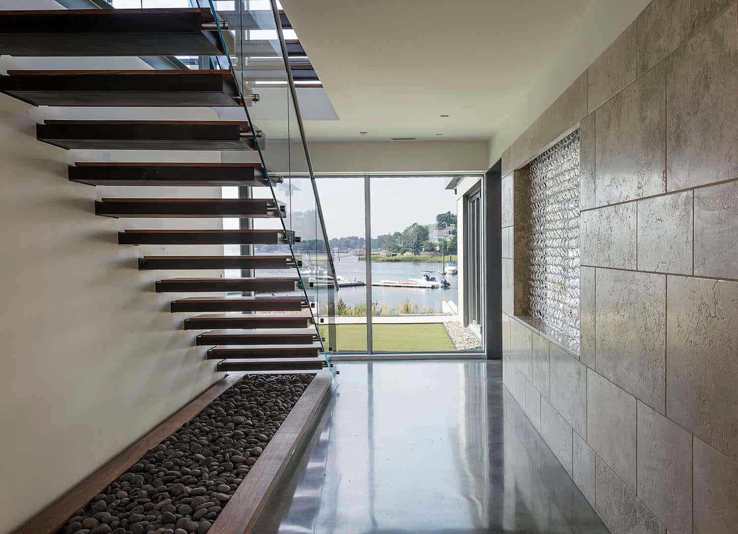 modern waterfront home entry with a staircase