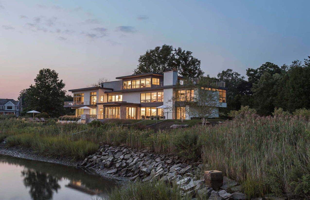 modern waterfront home exterior at dusk