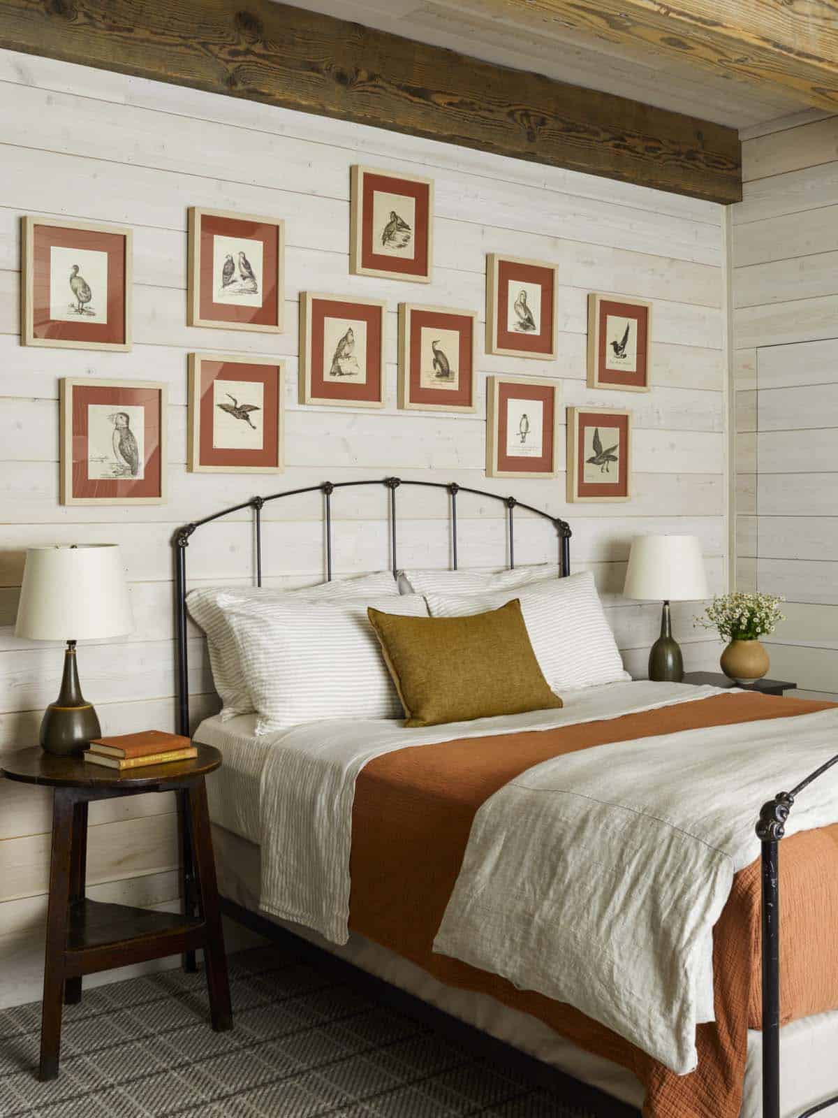 modern rustic bedroom with tongue and groove paneling in white and art gallery wall