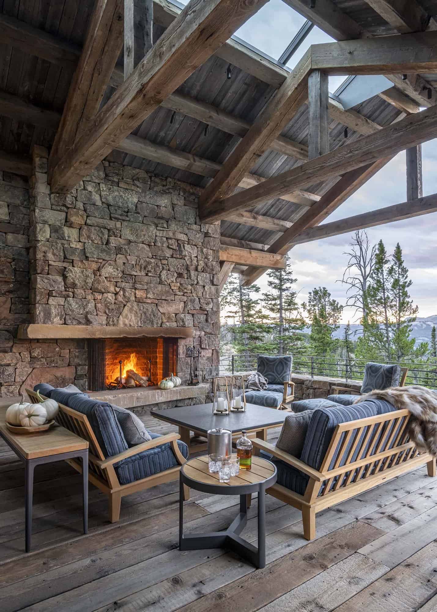 mountain home covered porch with an outdoor fireplace