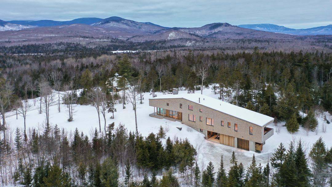 modern ski house exterior aerial view with snow