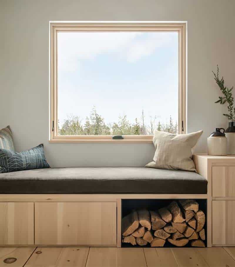 modern built-in window seat with a niche for fire log storage