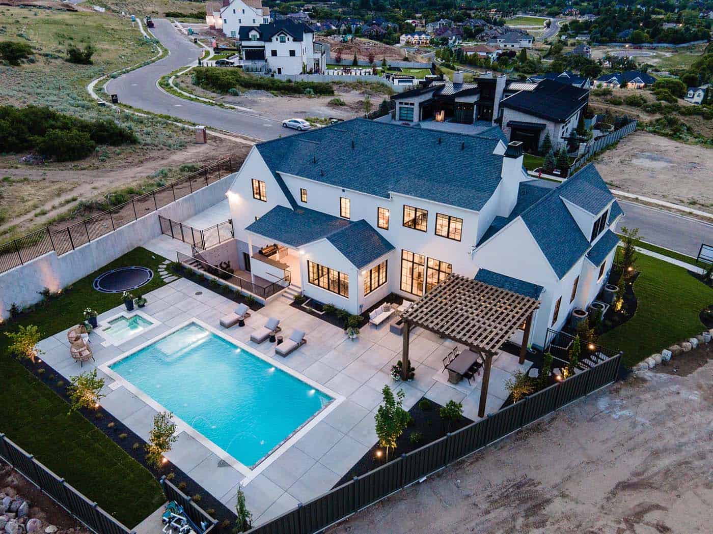 modern Tudor style home exterior with a pool aerial view