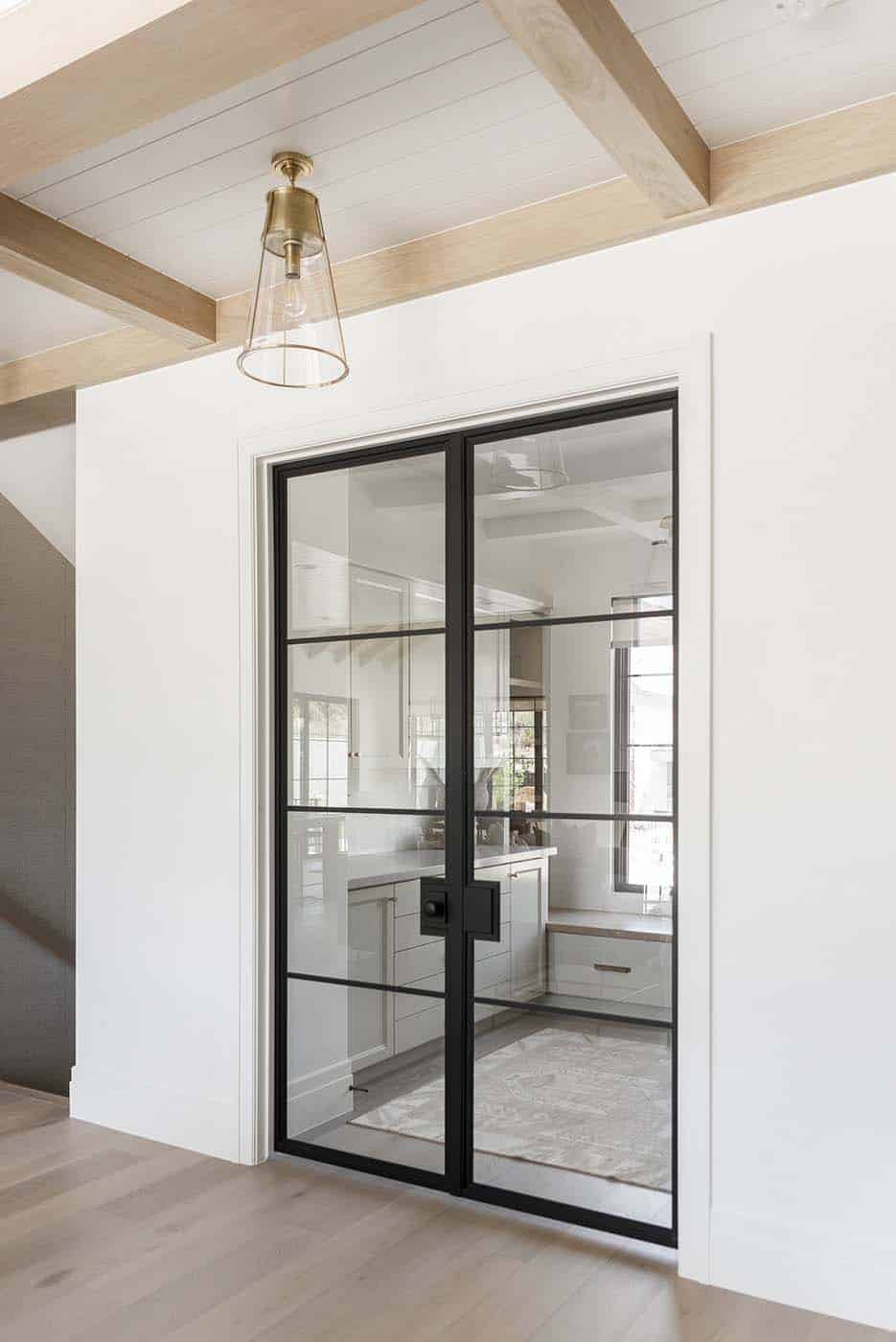 metal and glass custom fabricated doors leading into a modern home office