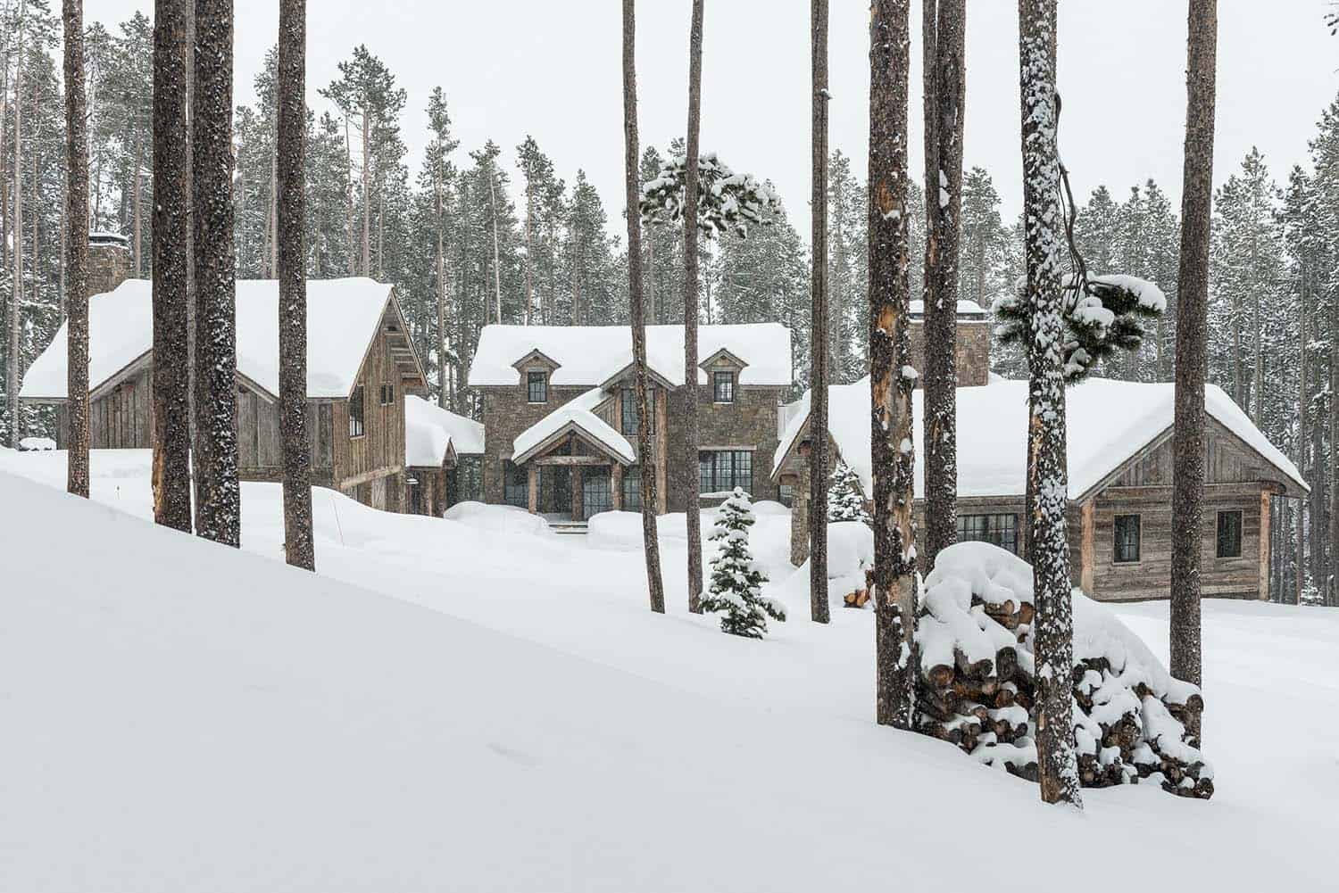 rustic mountain cabin in the woods surrounded by snow