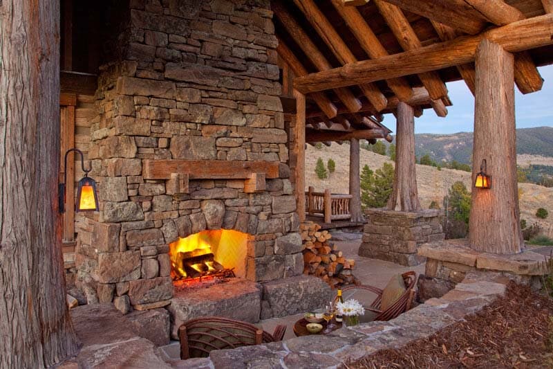 rustic mountain house exterior with a covered fireplace