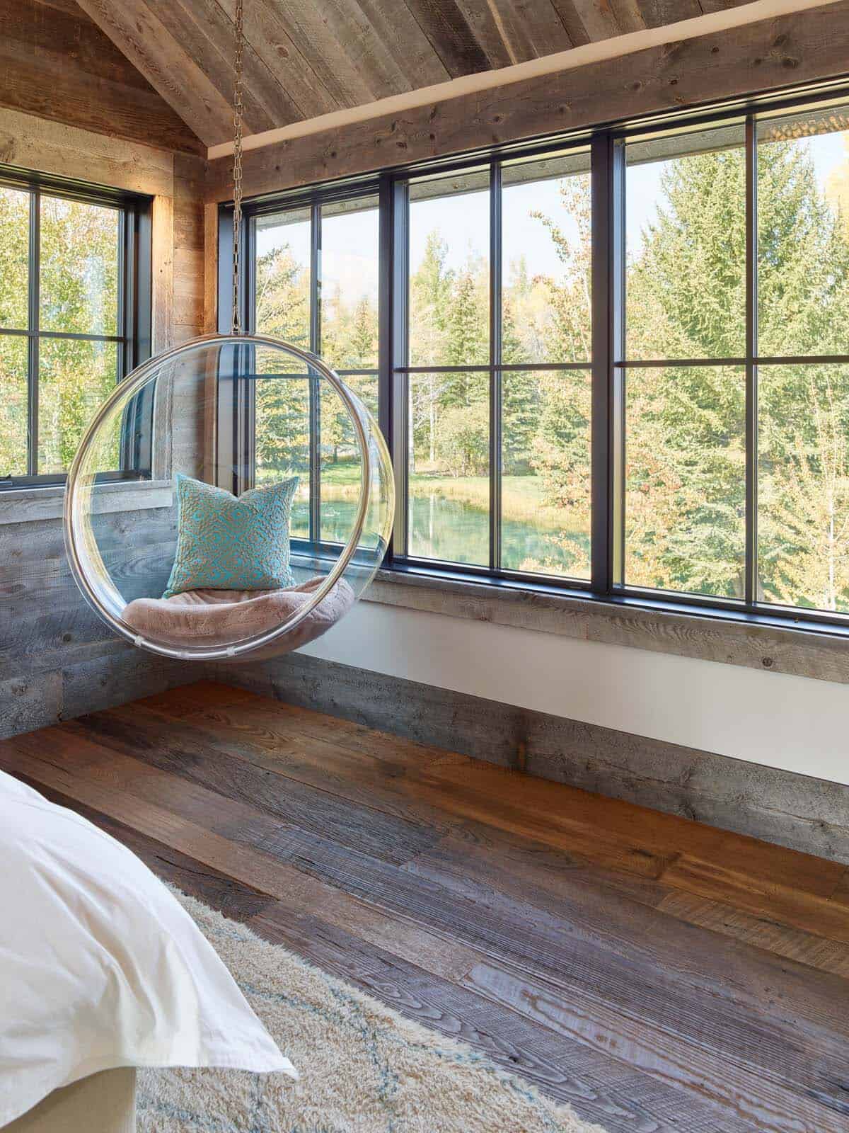 rustic bedroom with a hanging chair next to the window