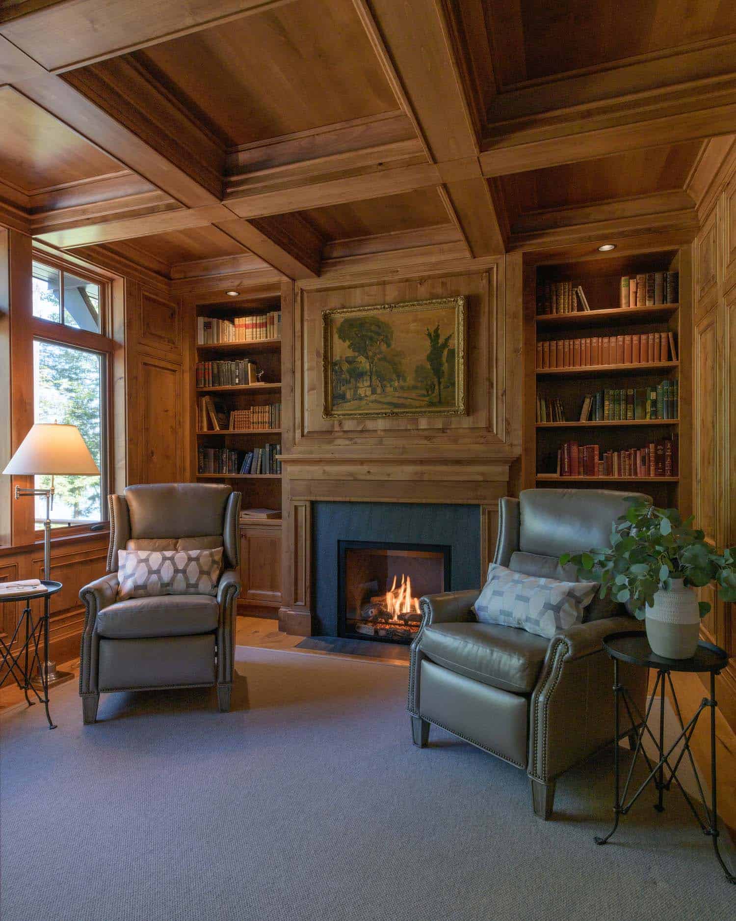 traditional home library with a fireplace