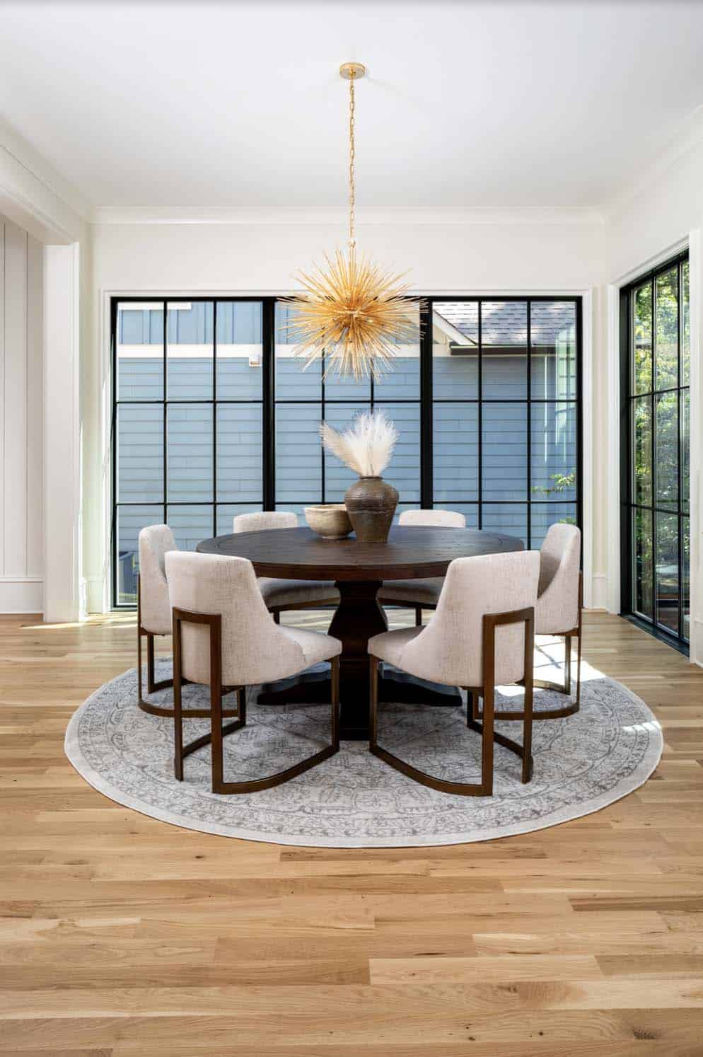 transitional style dining room with large windows