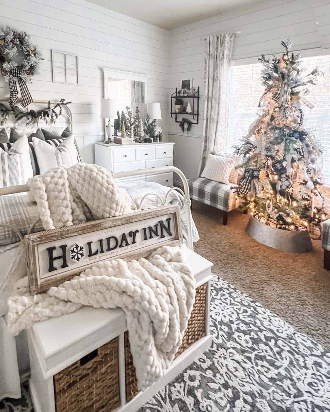 cozy bedroom with a holiday sign and Christmas tree