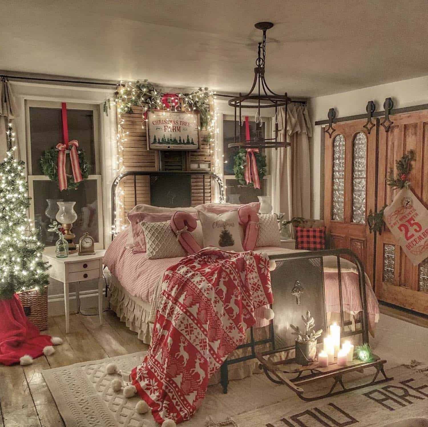 christmas decorated bedroom with red and white decorations and lighted trees