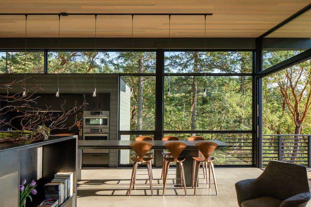 contemporary dining room with a forest view