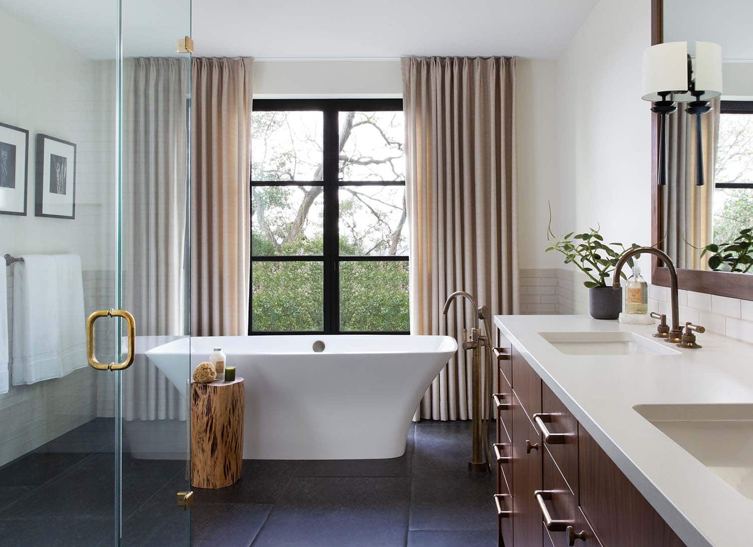 contemporary bathroom with a vanity, glass shower and soaking tub