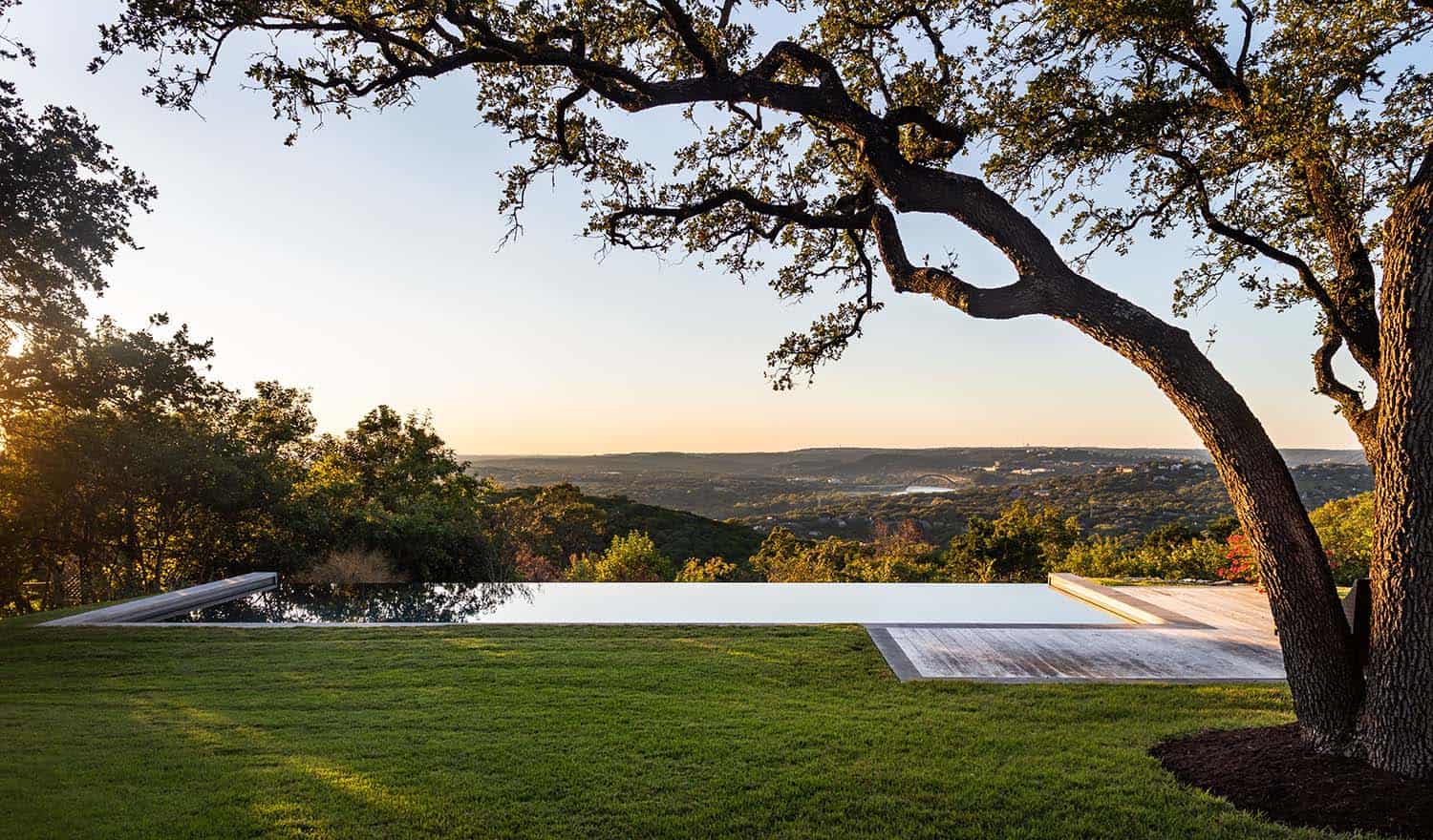 contemporary home exterior with a swimming pool and Texas Hill Country views