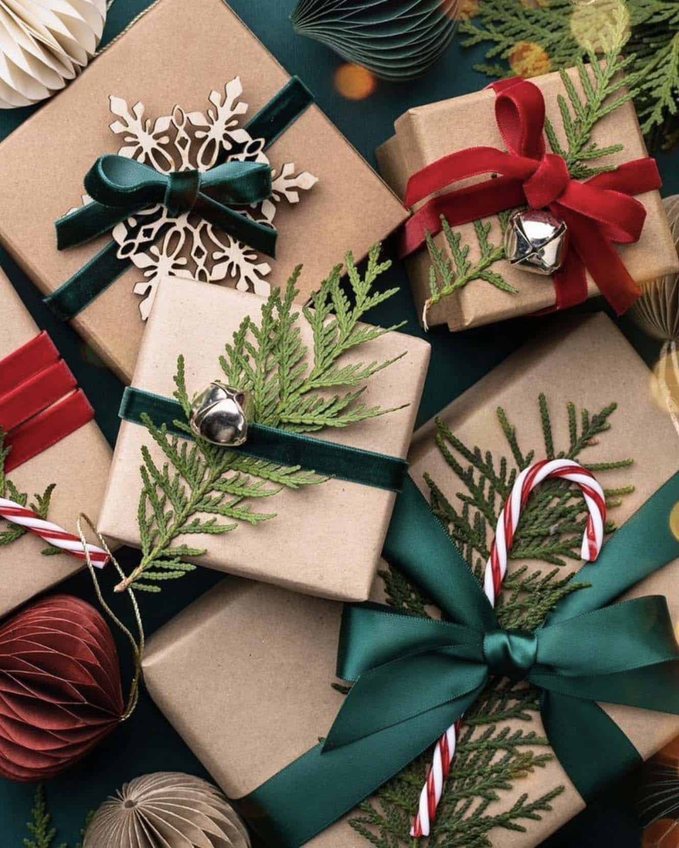 christmas gifts with silver bells, pine branches, ribbon and candy canes
