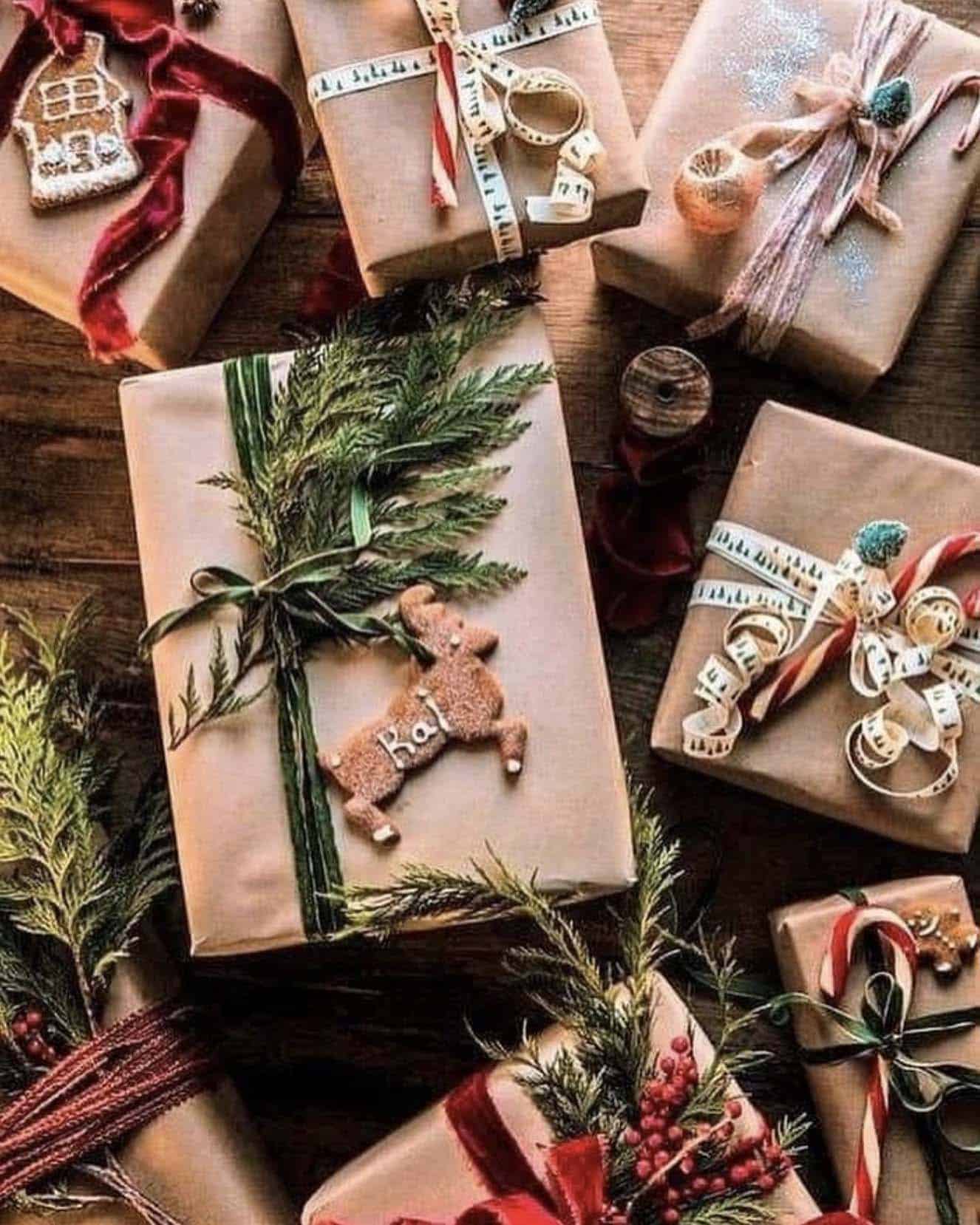 christmas gift wrapping with Kraft paper, ribbons and pine branches