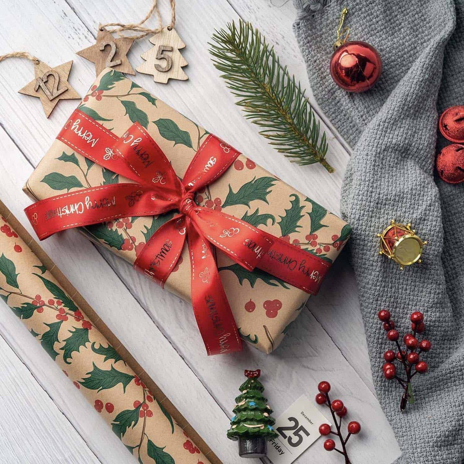 Kraft wrapping paper with holly and a red ribbon