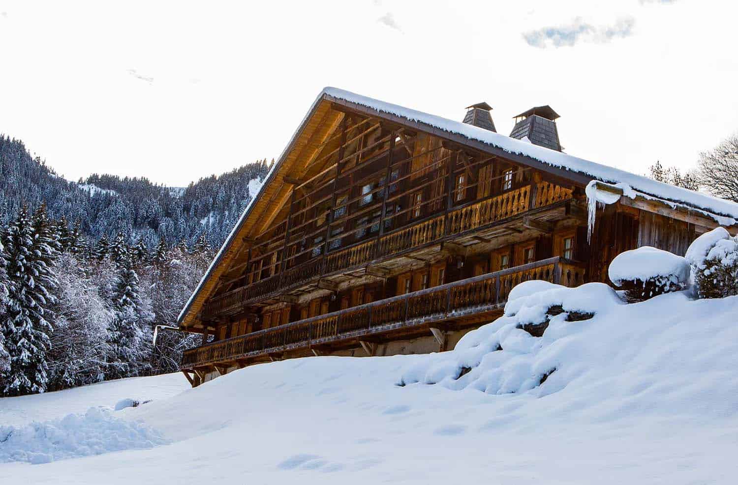 rustic mountain house exterior with snow