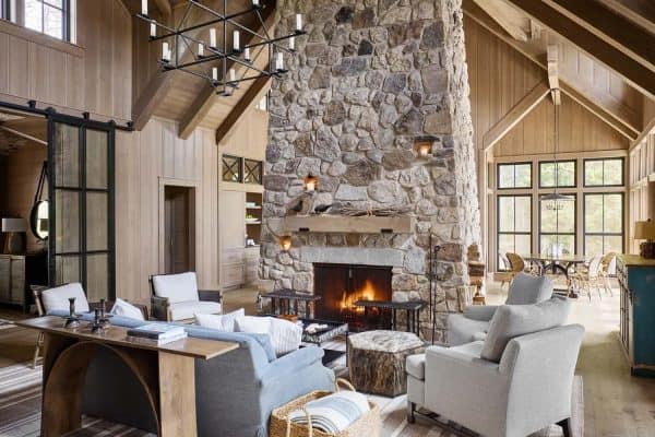 rustic living room with a large stone fireplace