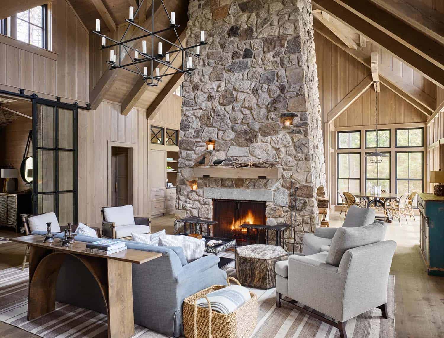 rustic living room with a large stone fireplace