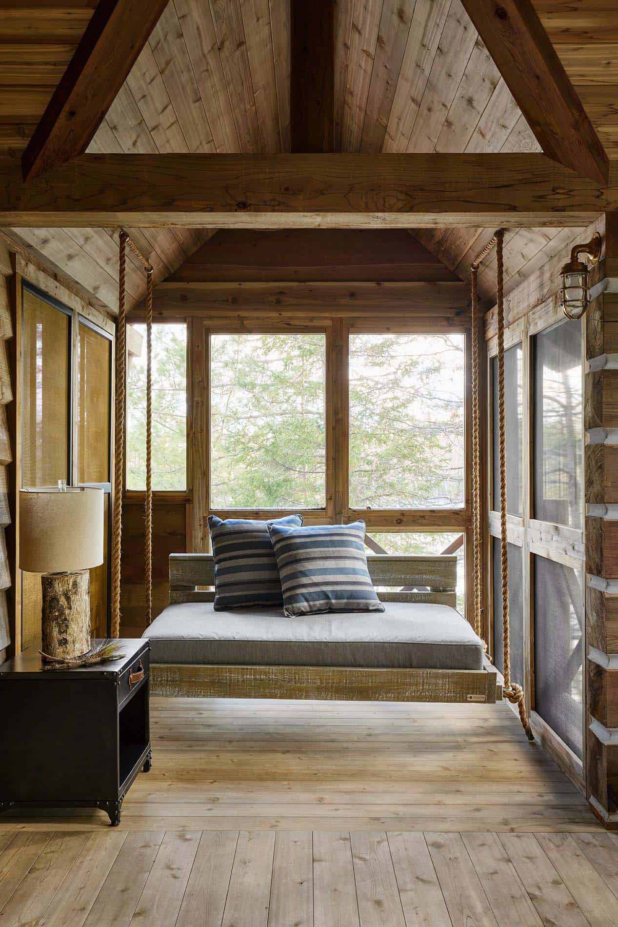 rustic screened porch with a hanging bed