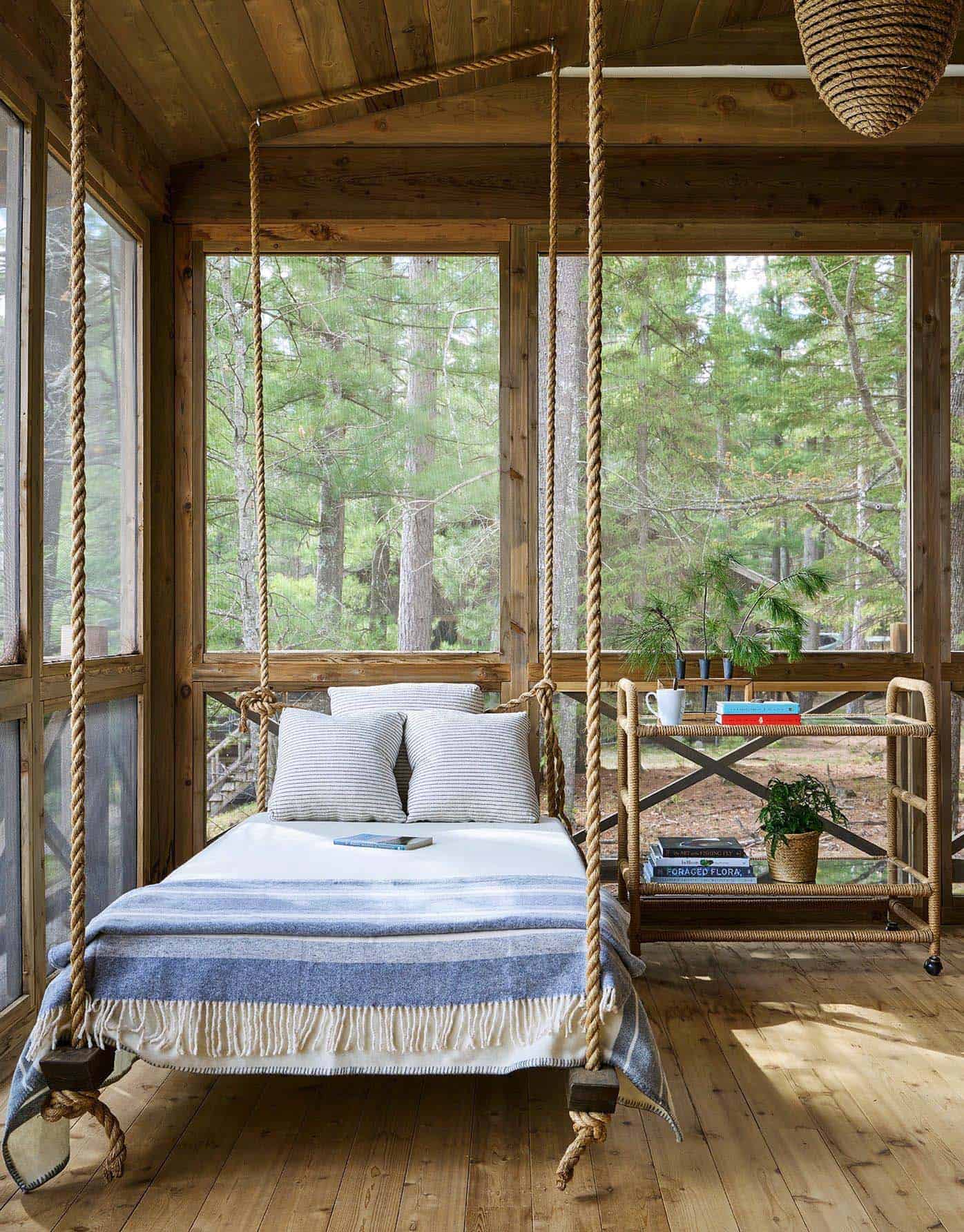 rustic screened porch with a hanging bed
