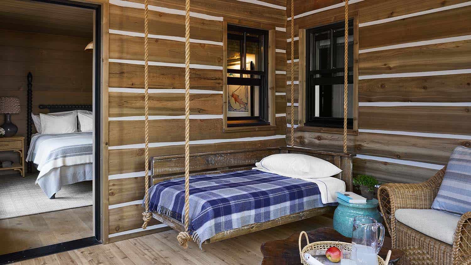 rustic bedroom sleeping porch with a hanging bed