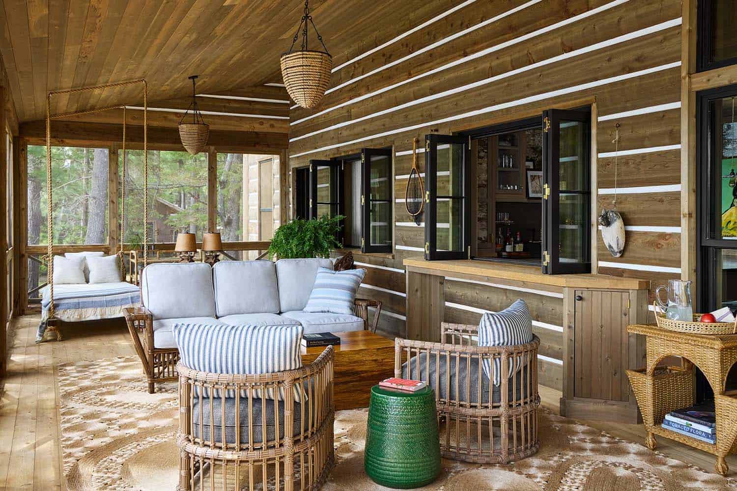 rustic screened porch with outdoor furniture and a pass-through window into the kitchen