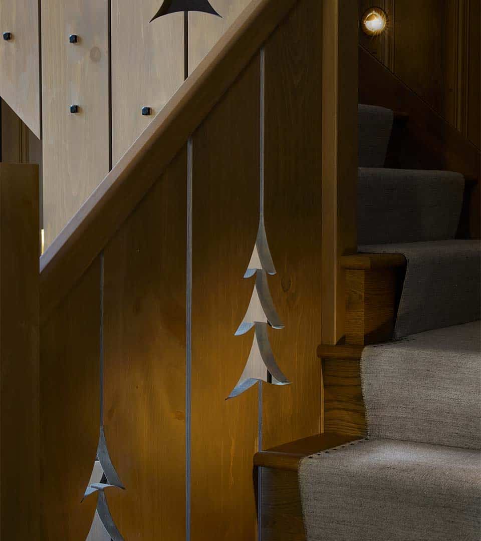 rustic staircase with wood paneling detail