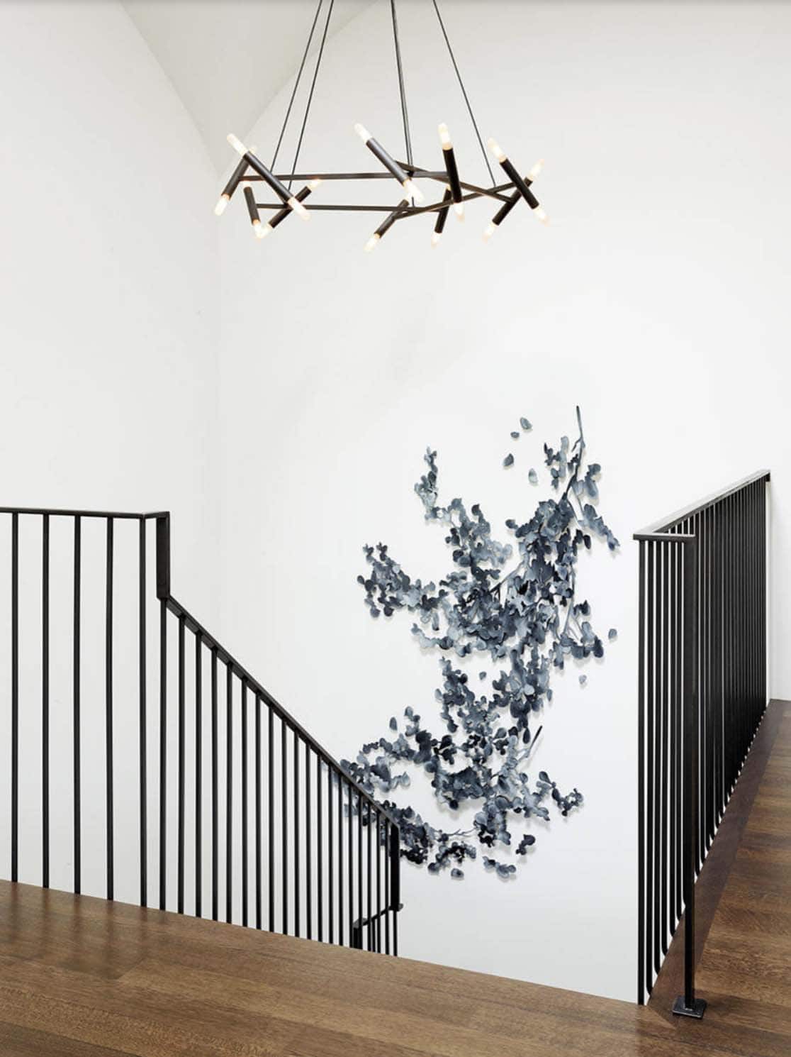 mediterranean style staircase with an art installation on the wall
