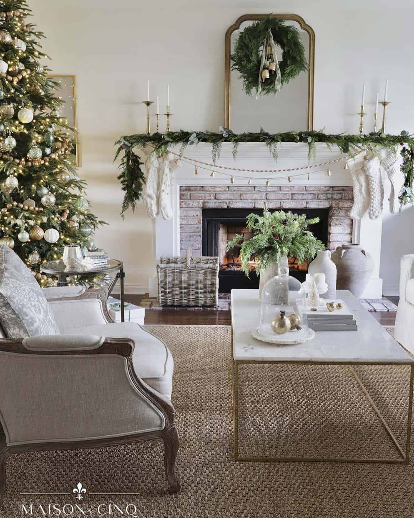 French-inspired Christmas in the living room with a tree and garland on the fireplace mantel