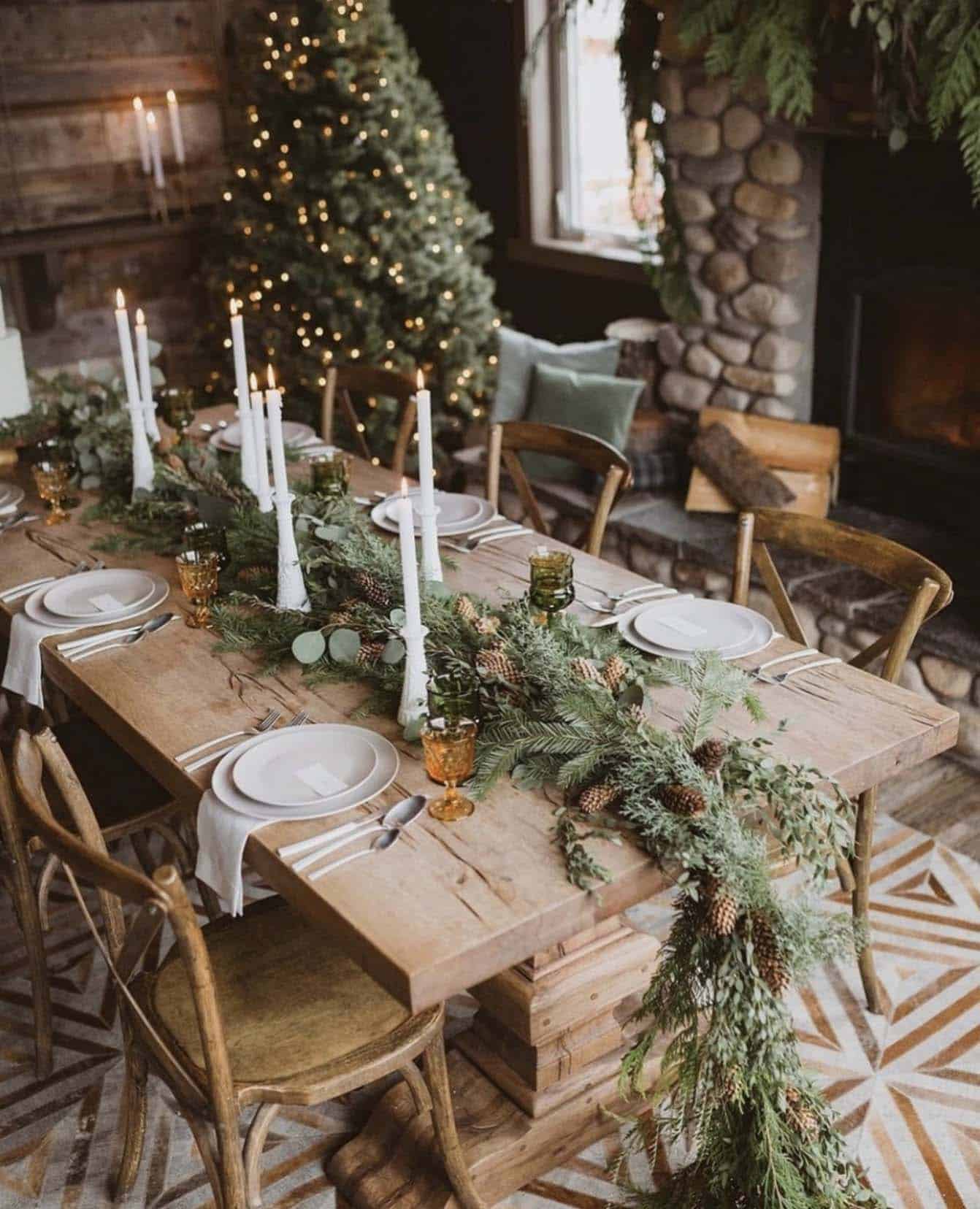 a cozy Christmas dining table with a garland centerpiece