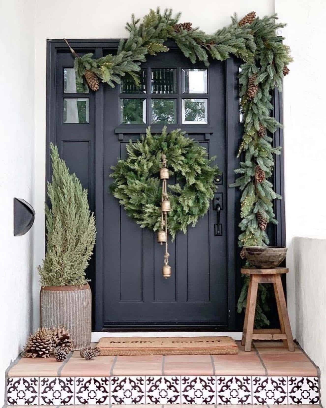front door with a christmas wreath and garland