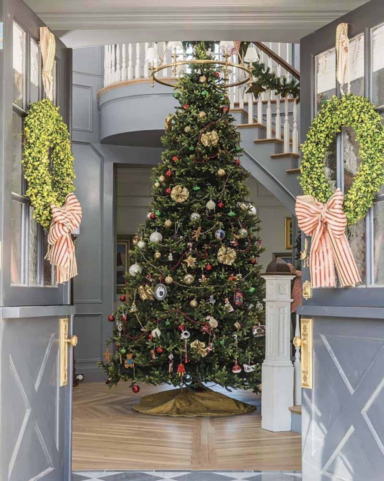 large christmas tree in the foyer with dutch doors