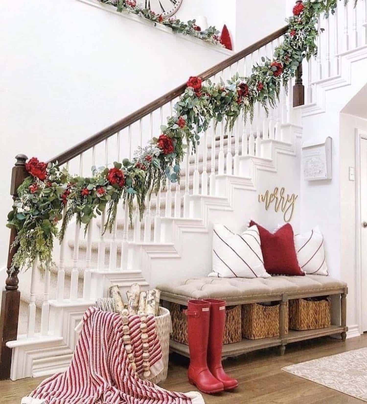 green garland with red roses on the staircase banister