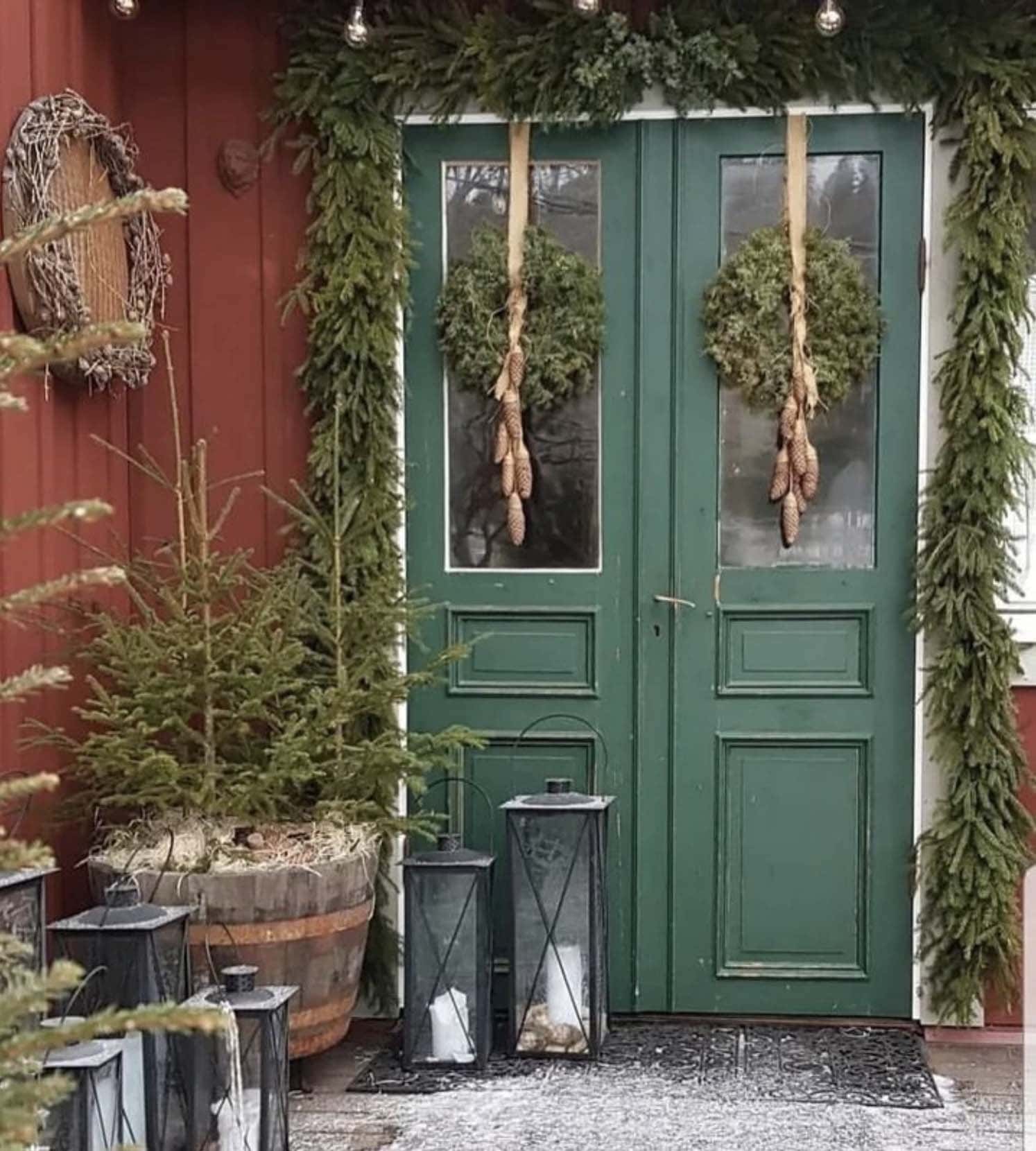 welcoming Christmas decorated front porch with wreath and natural pine garland