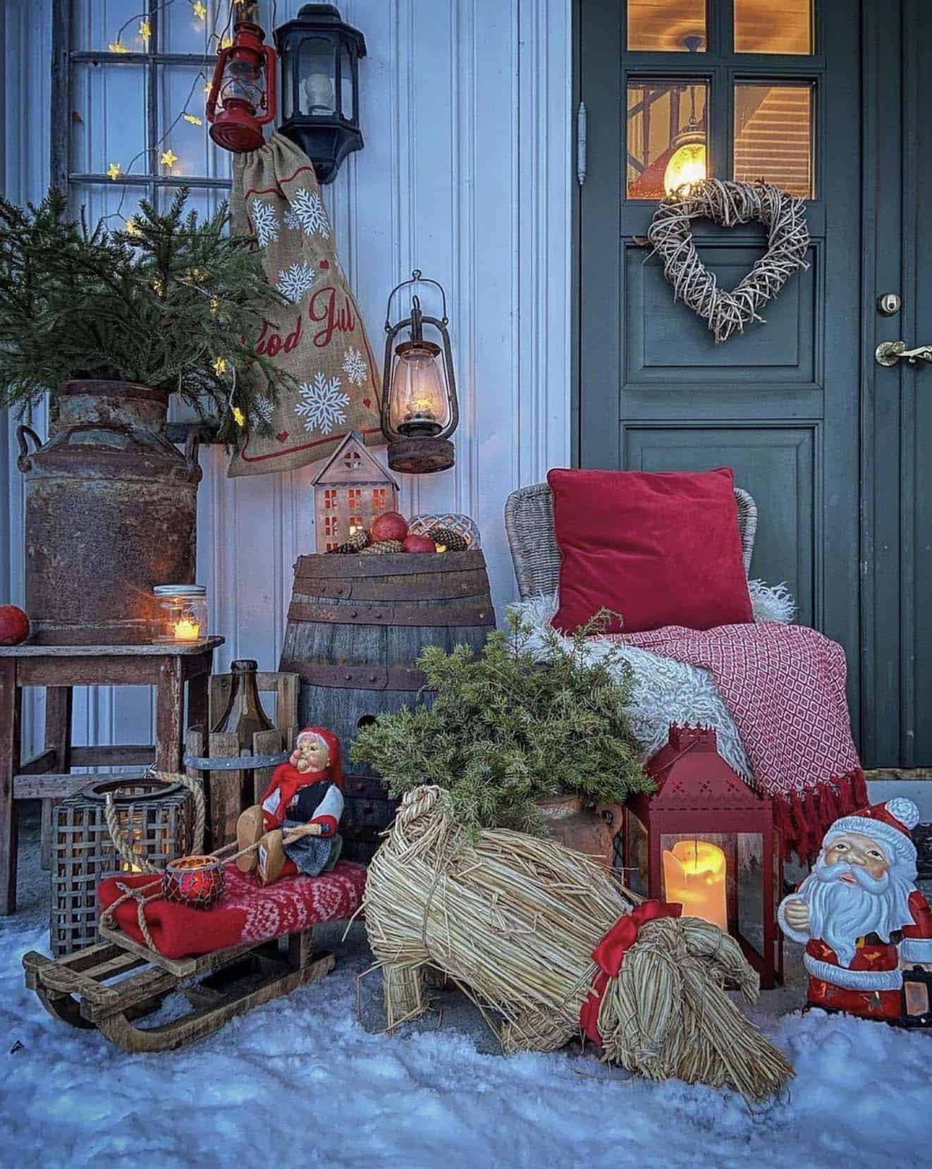 christmas decorated front porch with a straw pig and Santa Claus