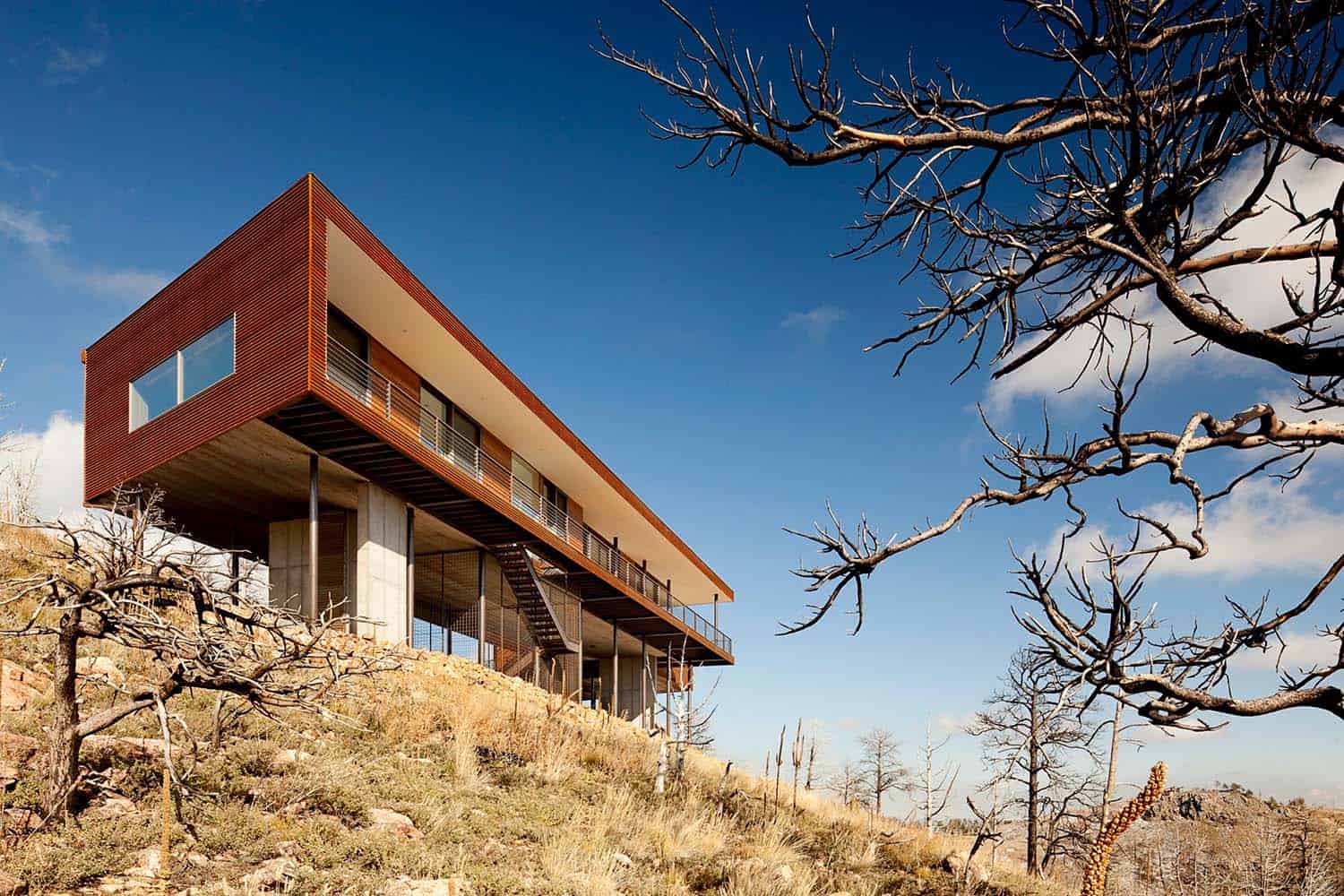 Modern house appears to float above the hillside with amazing Sunshine Canyon views
