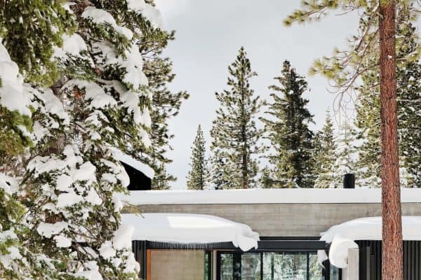 modern mountain house exterior with snow
