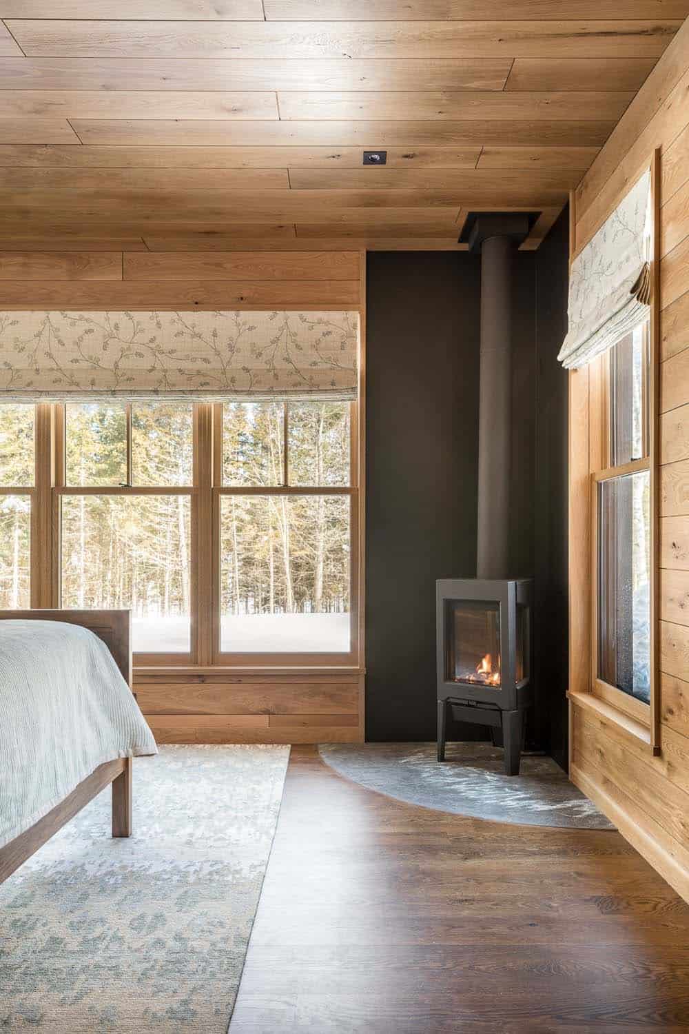 rustic bedroom with a freestanding wood stove fireplace