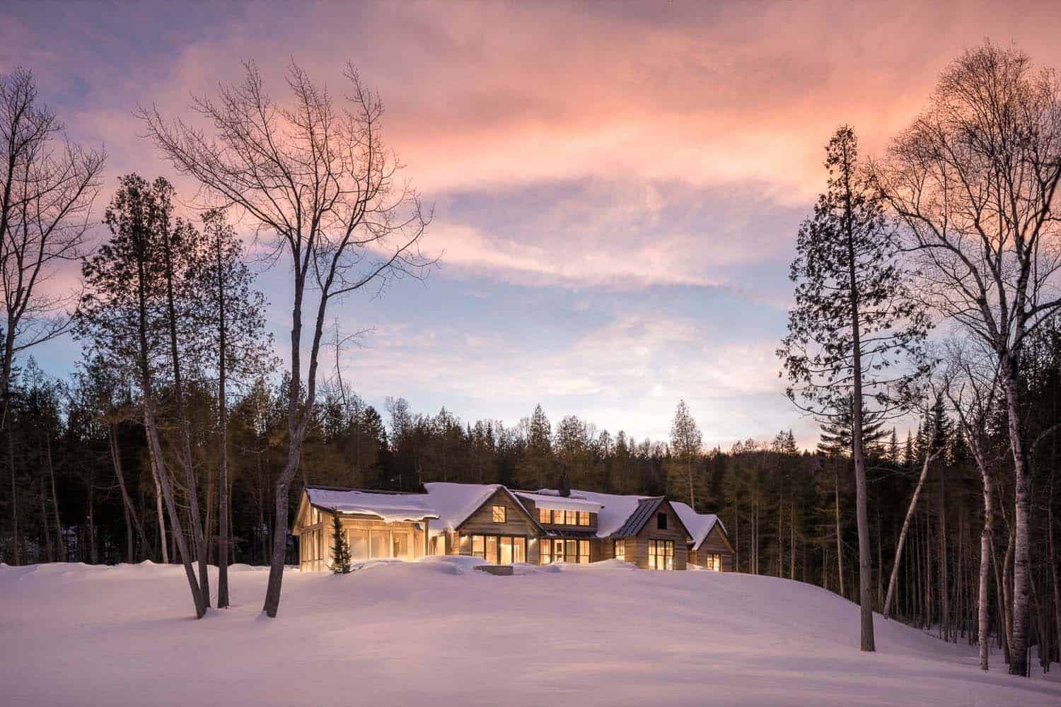 modern rustic mountain home exterior with snow